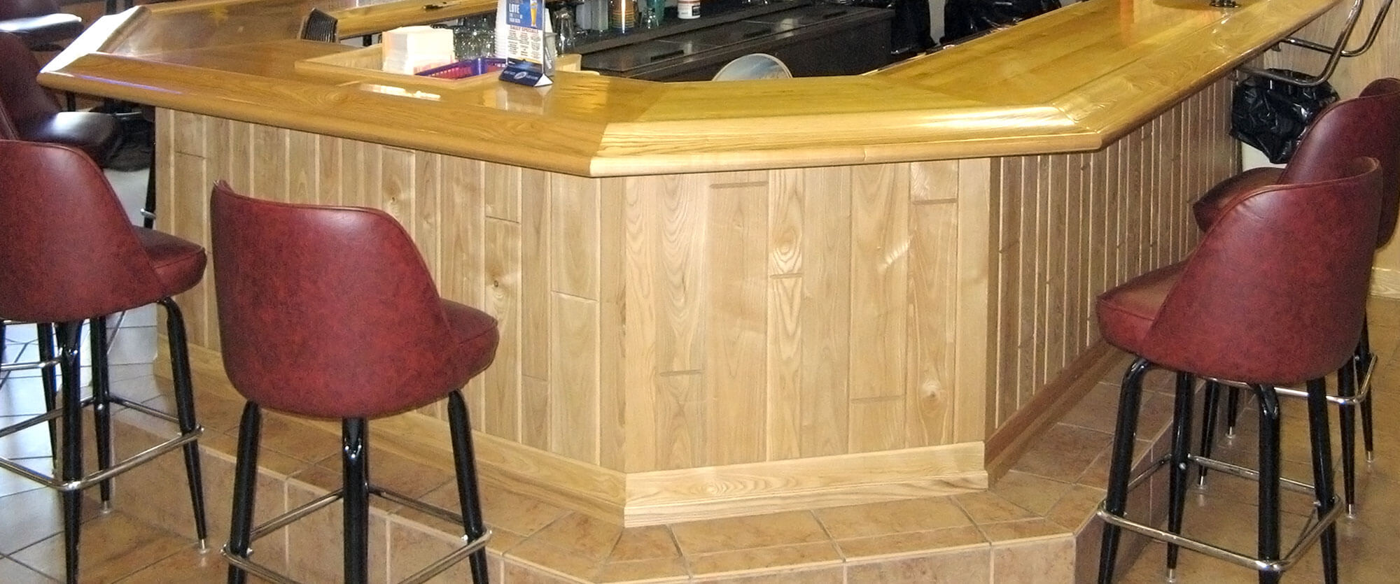 Large u-shaped wood bar top and base for the Osakis VFW; designed, built, and installed by finewood Structures of Browerville, MN